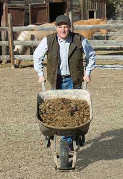 man pushing wheelbarrow